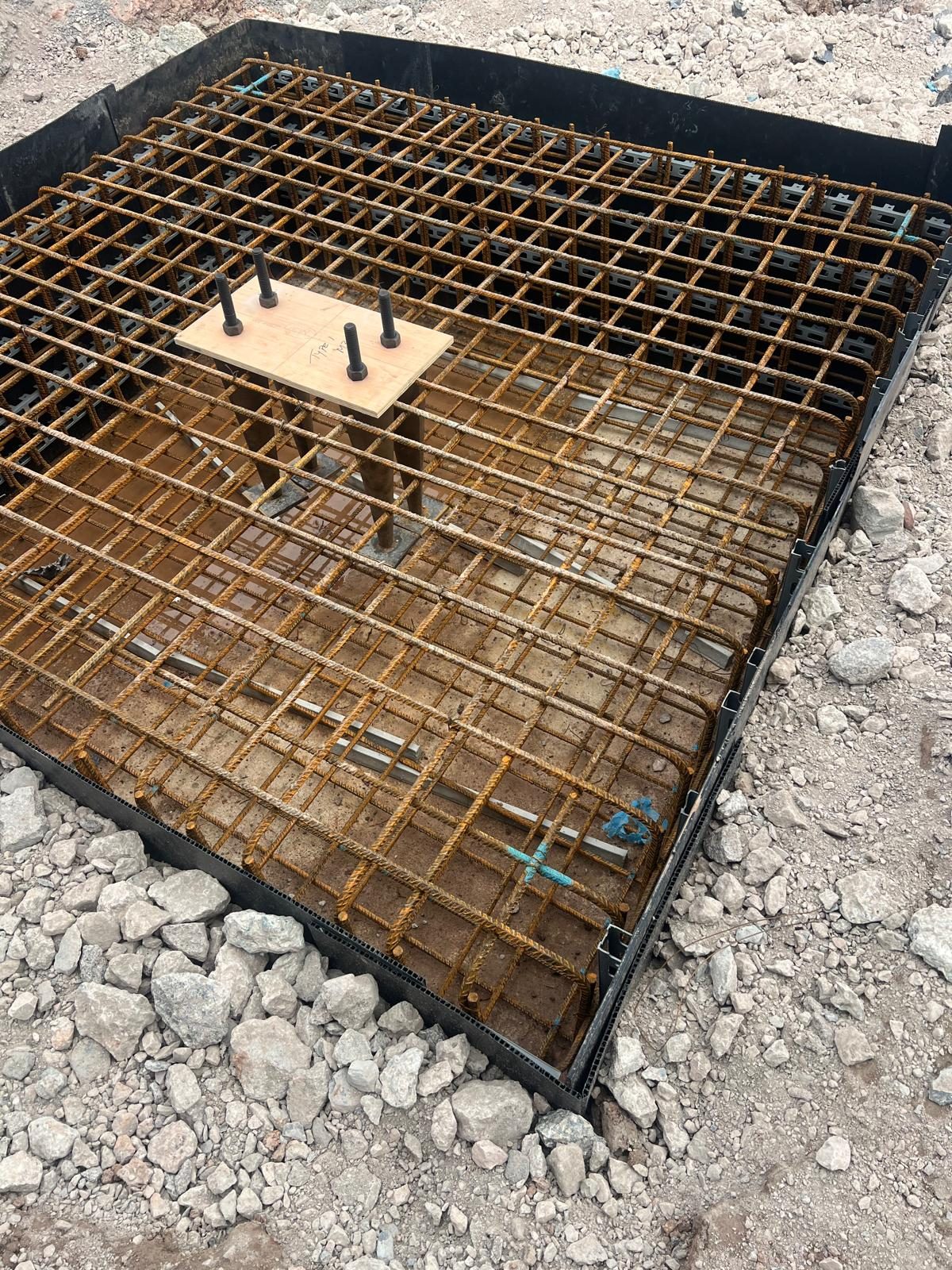 Pad foundation reinforcement cage set out on a stone base