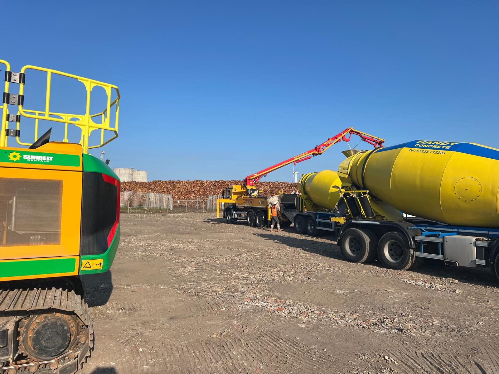 Mixer truck feeding a boom pump on site