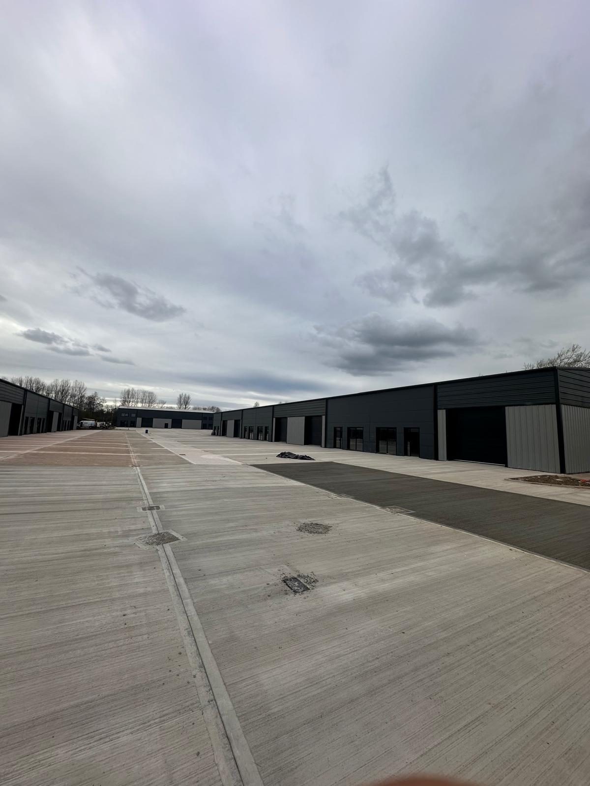 Large external concrete yard in front of industrial units